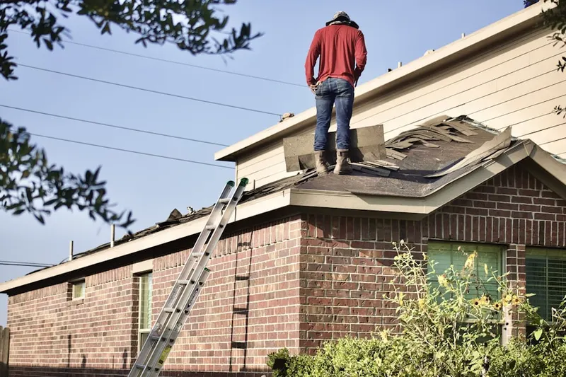 Professional roofer working on a residential roof in Ponderosa